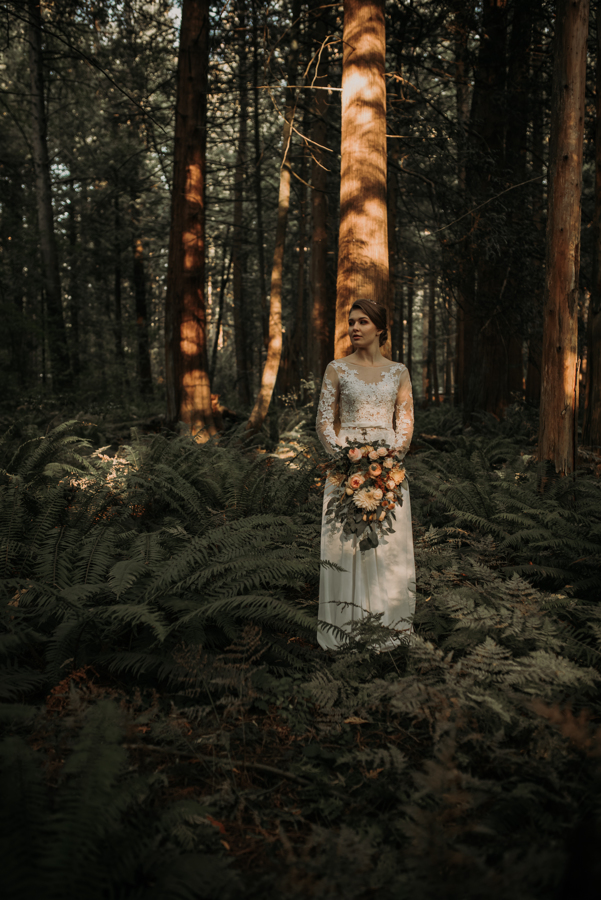 Forest Glam Inspiration bride walks through the forest of ferns on Vancouver Island
