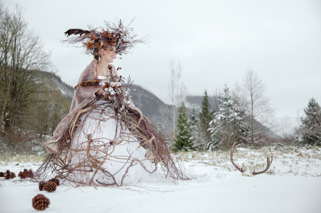Bride in snowy landscape covered in willow twigs by Deborah Lee Designs