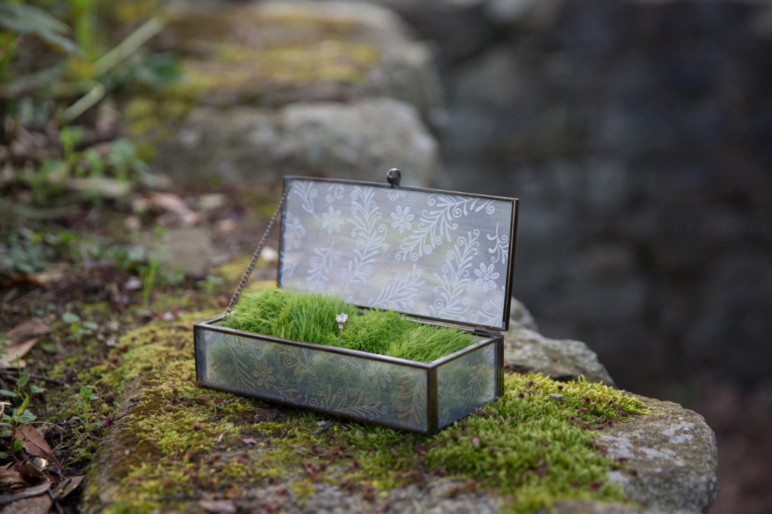 Wedding Rings in glass box filled with moss