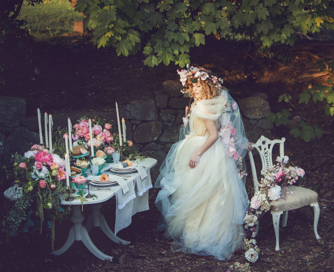 Romantic spring bride in outdoor garden reception of pink peonies