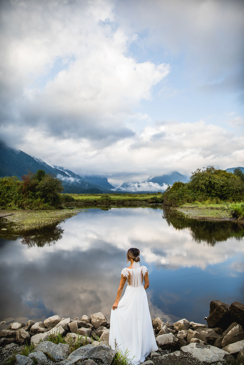 Bride looks out at Pitt Lake by Katie Lauren Photography