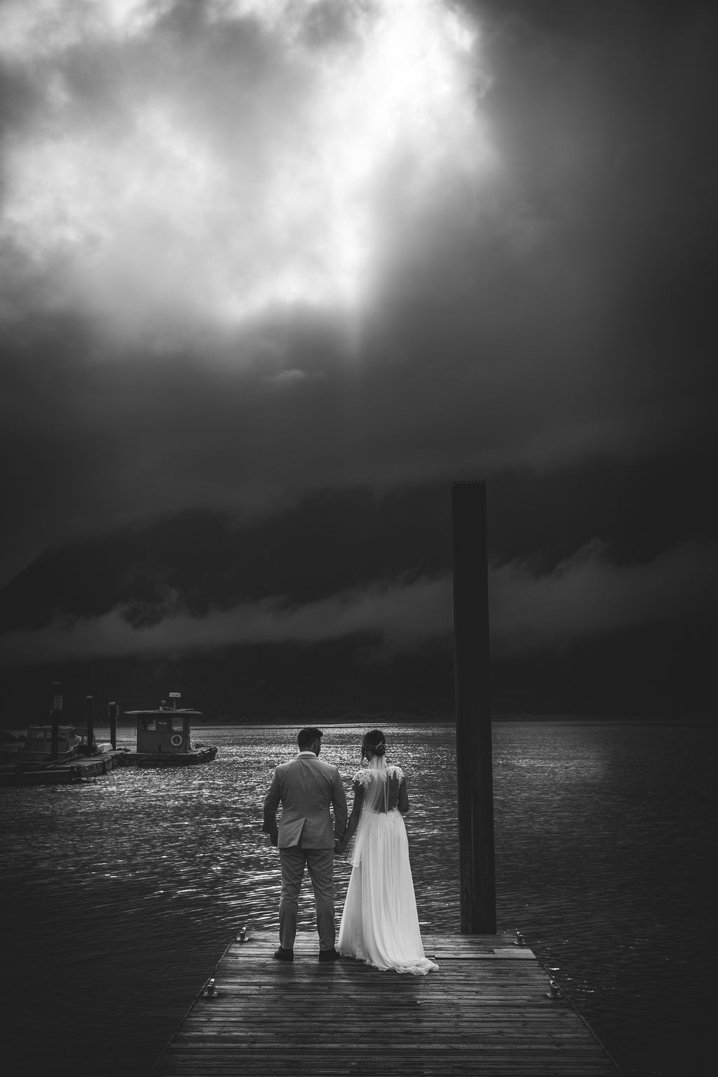 Newlyweds looking at storm clouds by Katie Lauren Photography