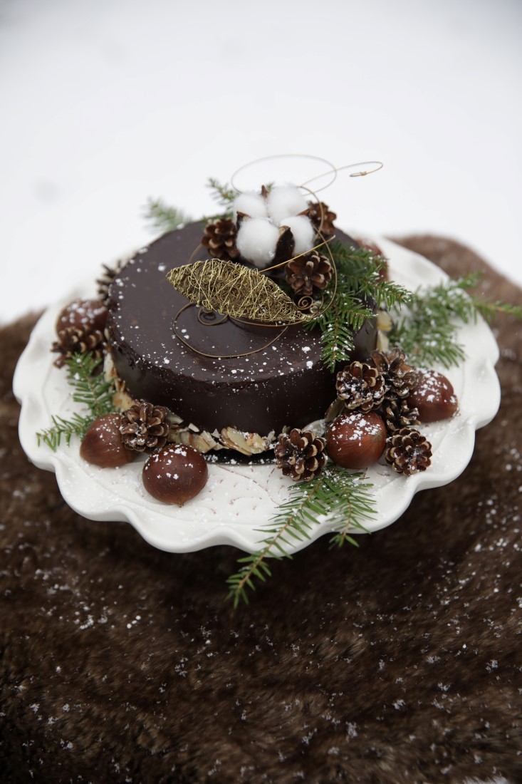 Wedding Chocolate Cheesecake covered in pine cones and twigs