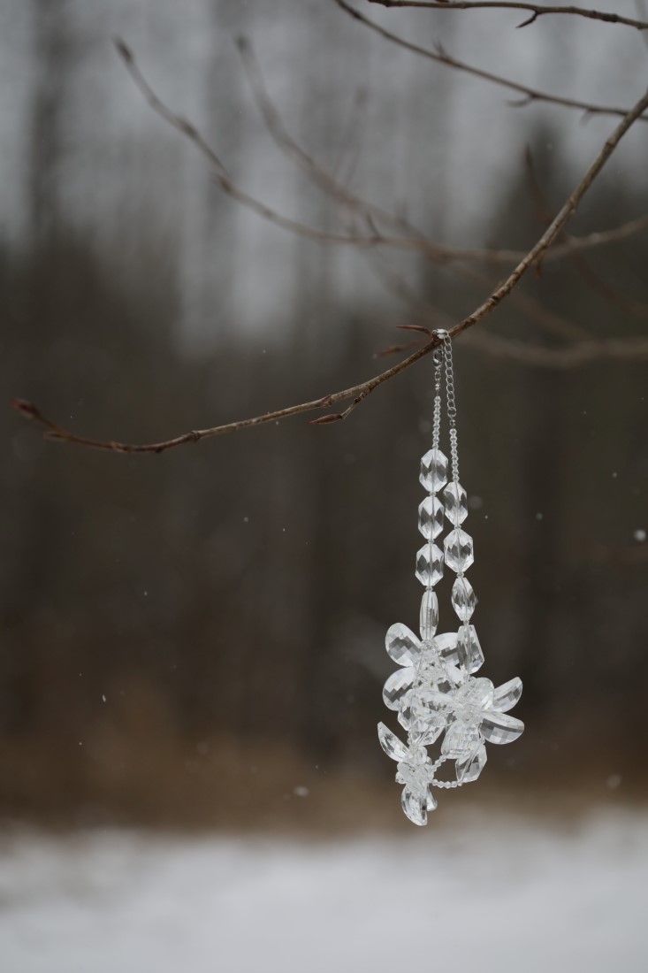 wedding crystals hang from winter pine tree by White Album Weddings
