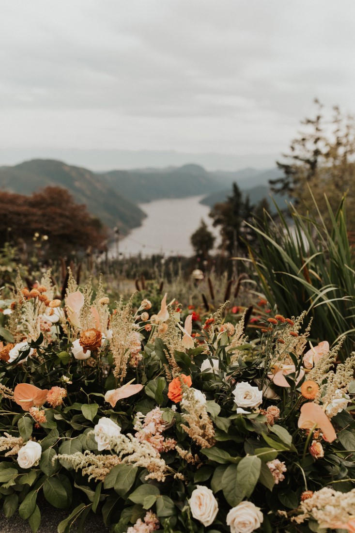 View of Vancouver Island ocean framed by wedding flowers at Villa Eyrie