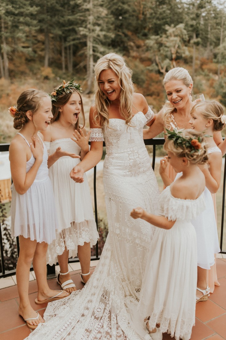 Bride surrounded by bridesmaids wearing blush gowns 