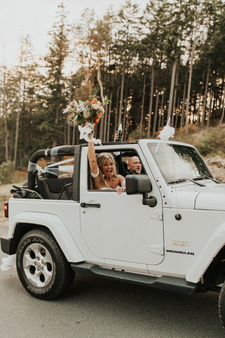 Newlyweds in white jeep Cherokee on Vancouver Island