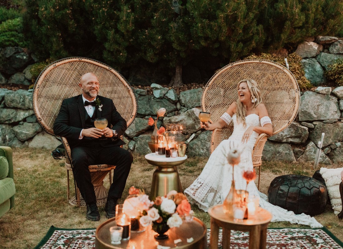 Bride and groom sit in wicker chairs at Villa Eyrie Vancouver Island