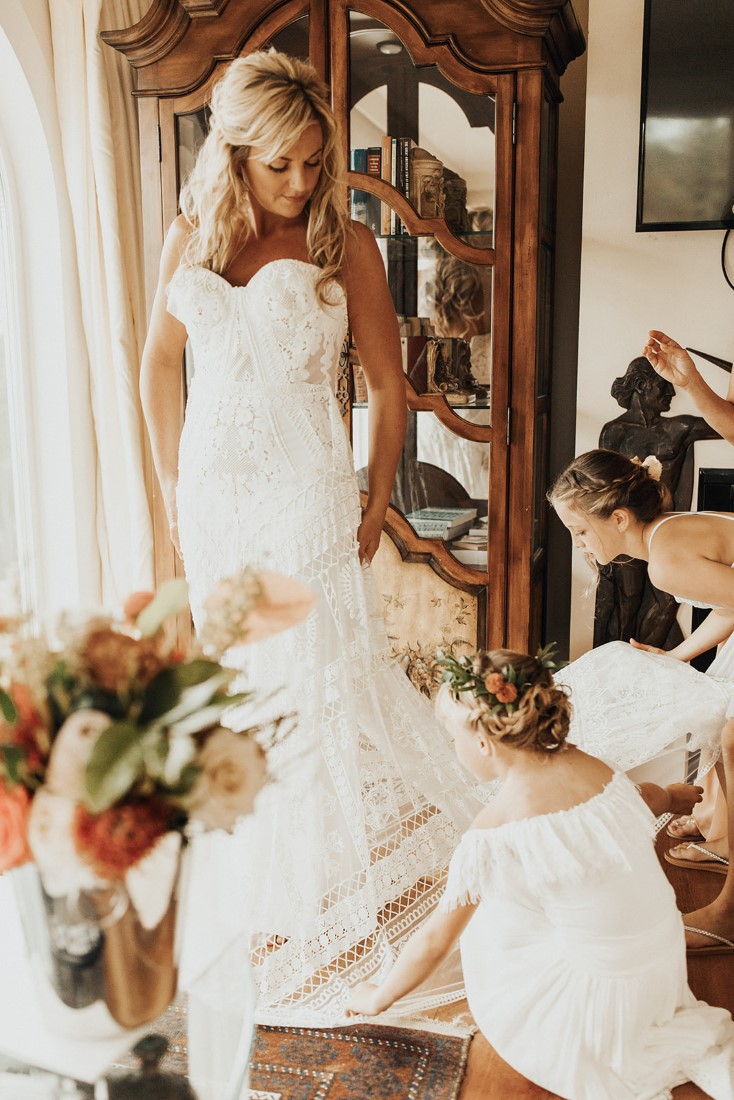 Bride puts on wedding gown at Villa Eyrie