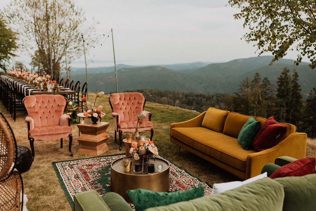 Mustard yellow couch and blush velvet chairs at outdoor wedding sitting area 