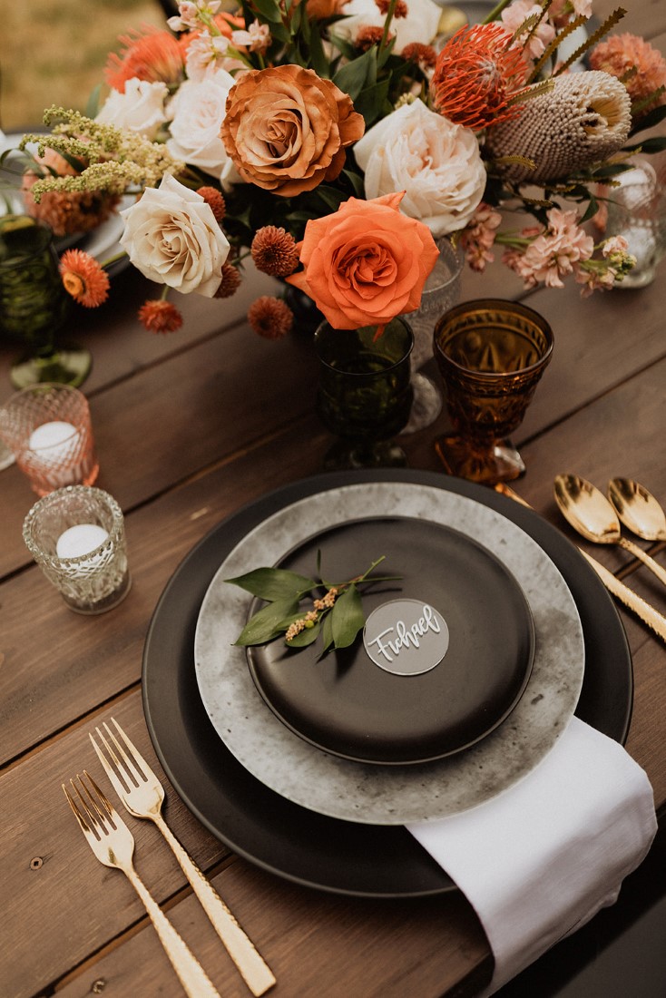 black plates and gold cutlery for wedding reception farm table by Party Mood