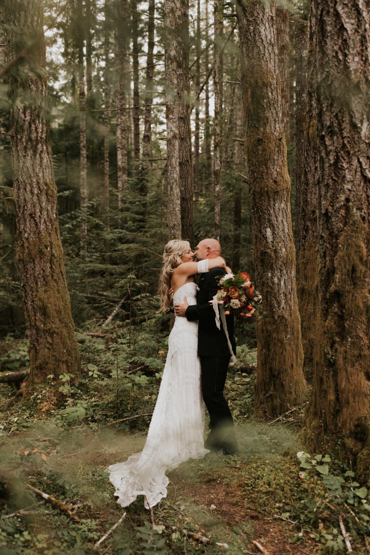 Newlyweds Kristee and Travis kiss in the Vancouver Island forest