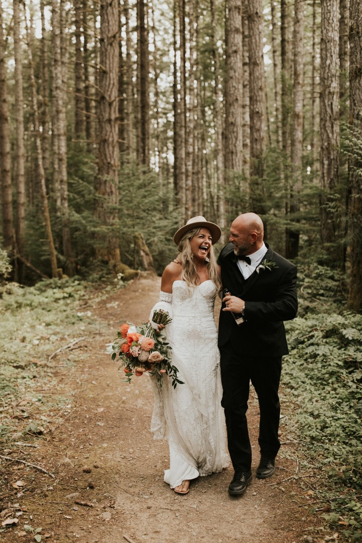 Newlyweds walk along Vancouver Island mountain trail 
