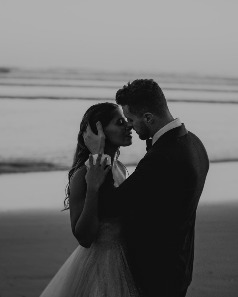 Black and White shot of engaged couple in formal wear on Tofino beach