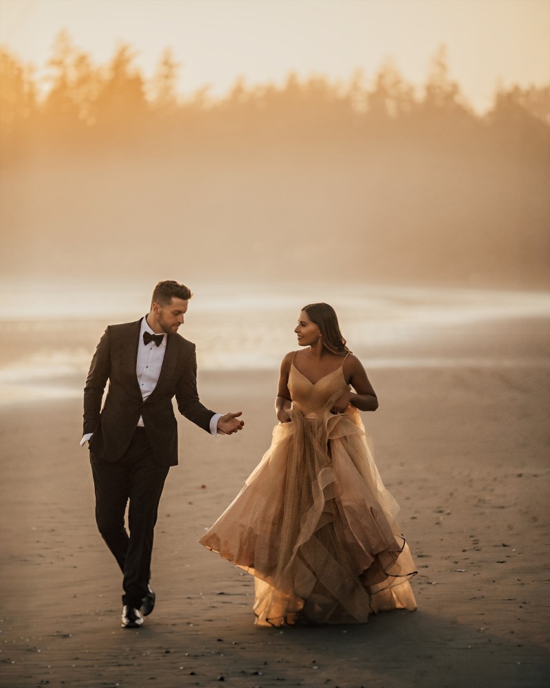 Bride and Groom walk along Tofino beach 