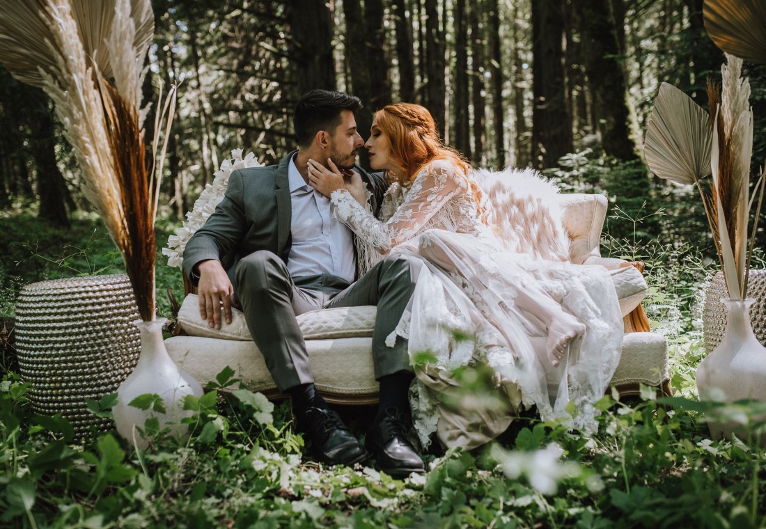 Lovely wedding couple on white couch in the Vancouver Island forest