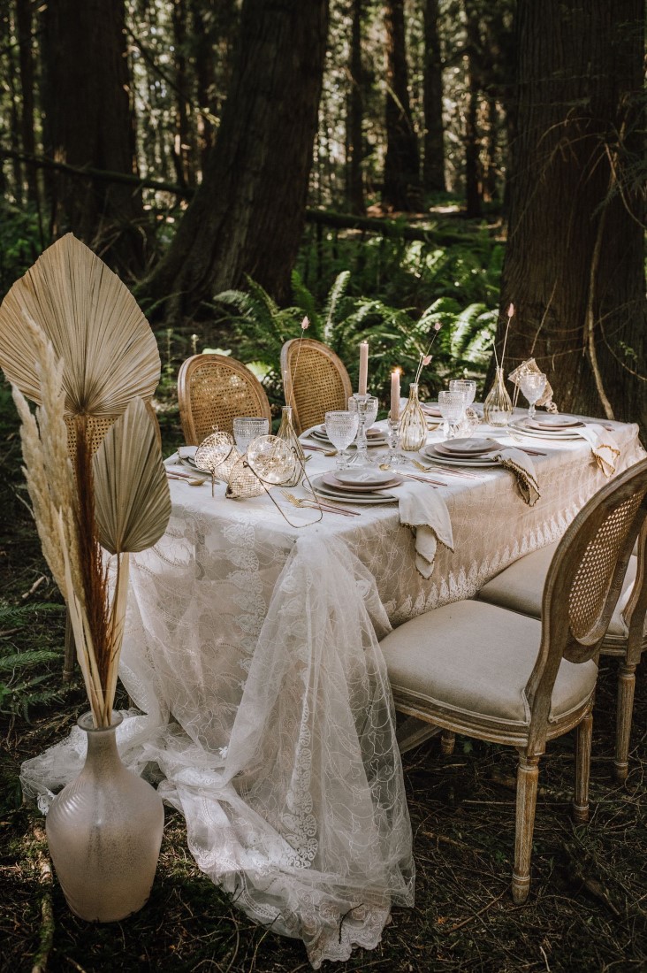 Pampas grass along lace covered forest wedding table 