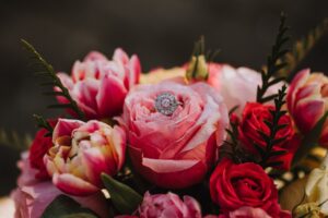 Crisp pink roses with diamond wedding ring by Chelsea Warren