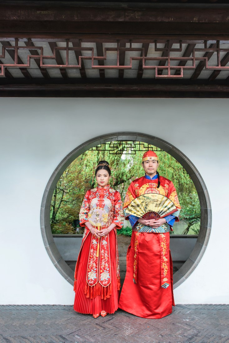 Chinese engaged couple holds traditional good luck