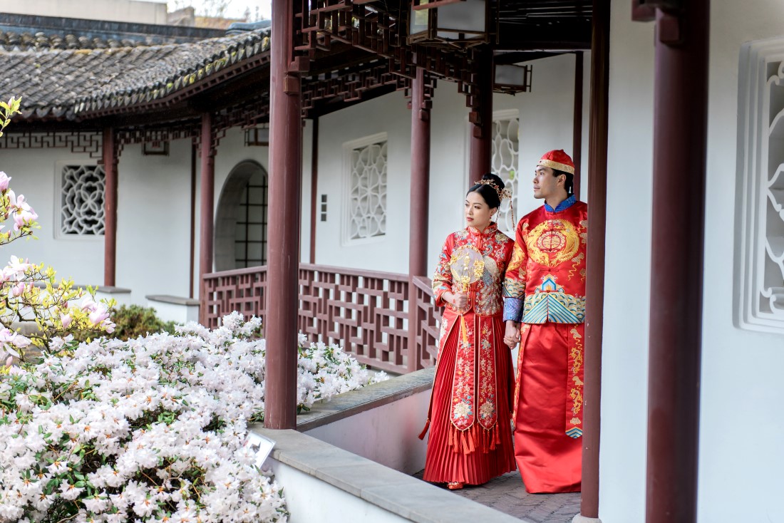 Chinese fusion couple walk through the portico in Vancouver