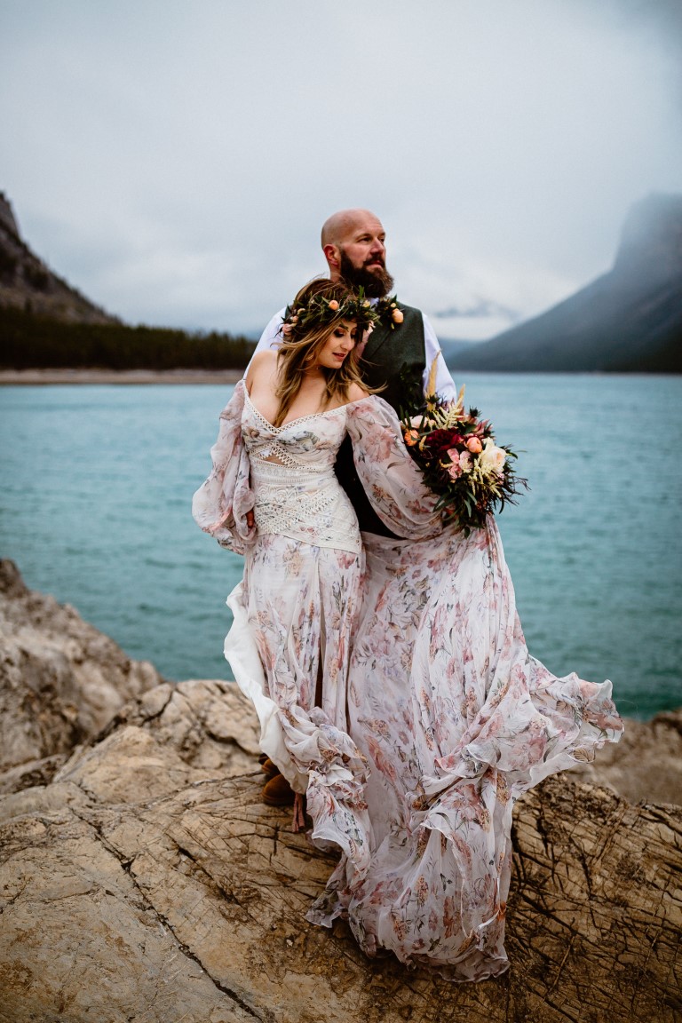Eloping couple stand in front of BC lake by Film and Forest