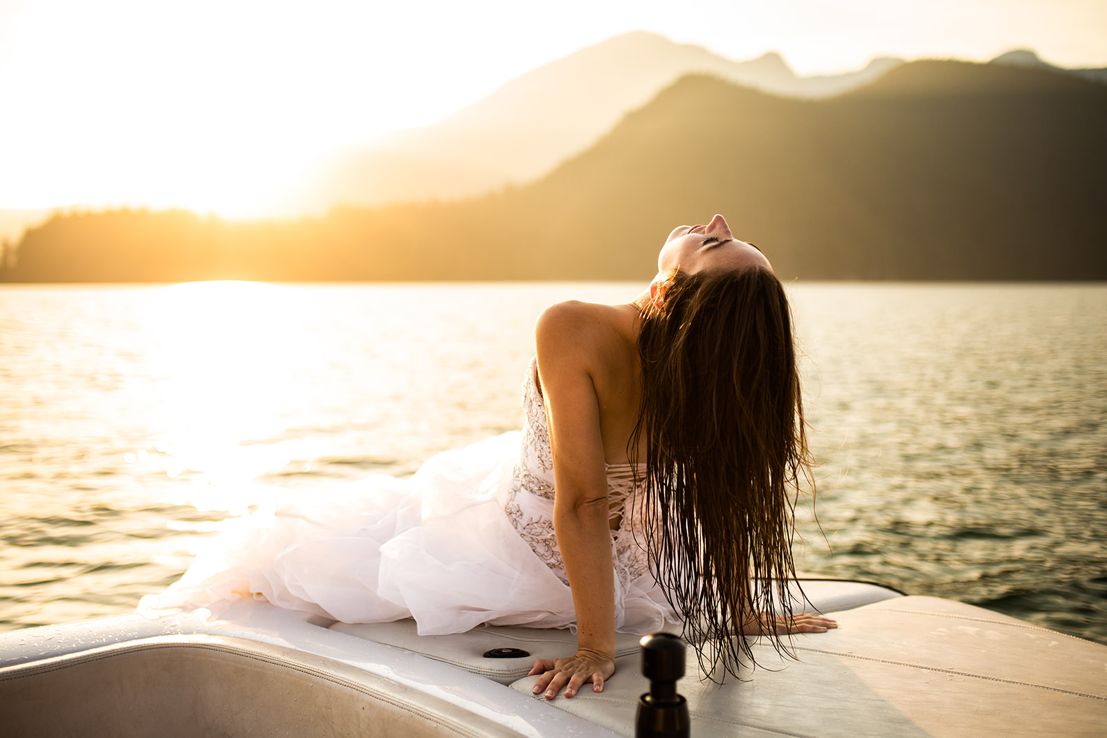 Bride leans back on front of speed boat 