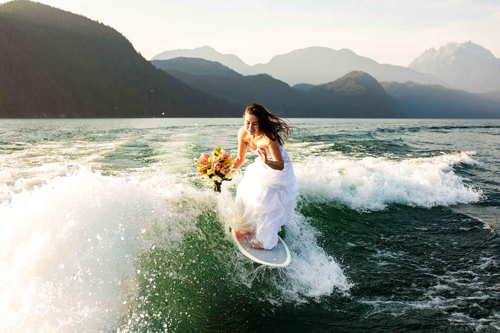 Surfer Bride Adventure on Vancouver Lake holds bouquet 