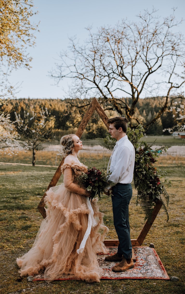 elopement ceremony in front of wood backdrop on Yellow Point Farm