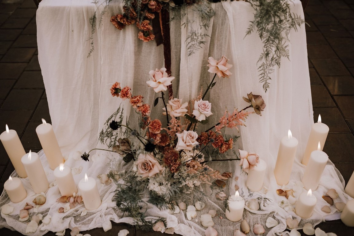 spray of roses and candles around table