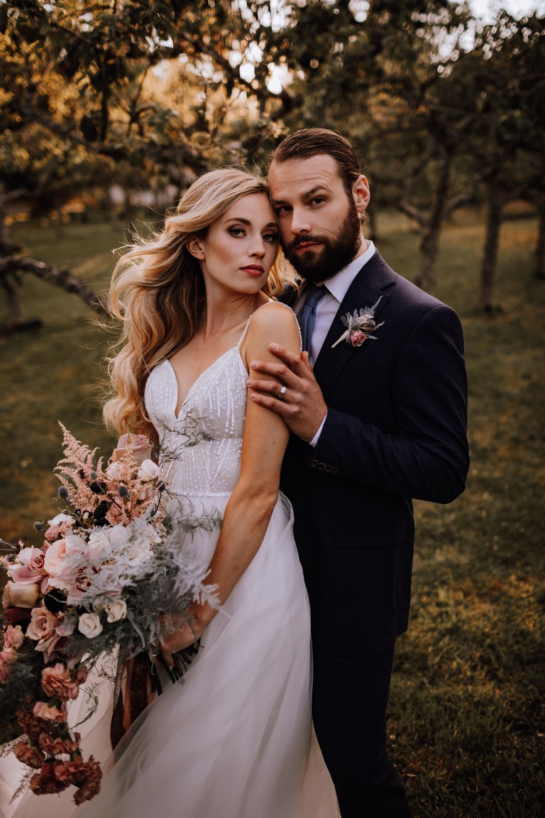 Couple poses in field