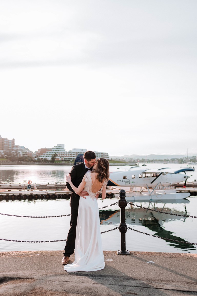 Ocean + Ink Victoria Elopement couple kiss with Harbour Air place