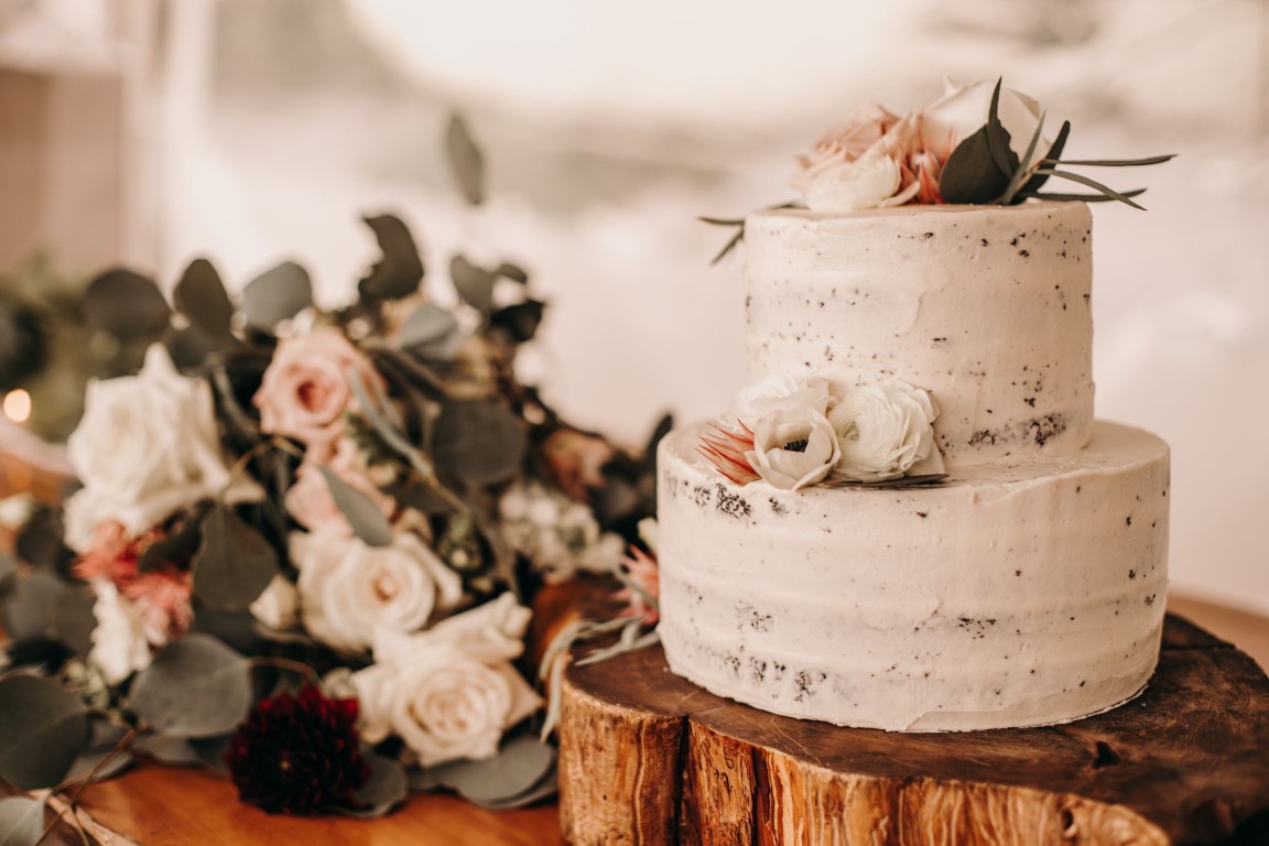 White frosted wedding cake with roses