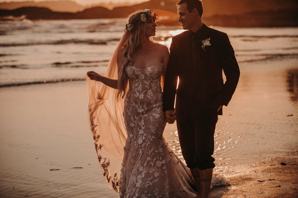 Couple strolls along Tofino Beach