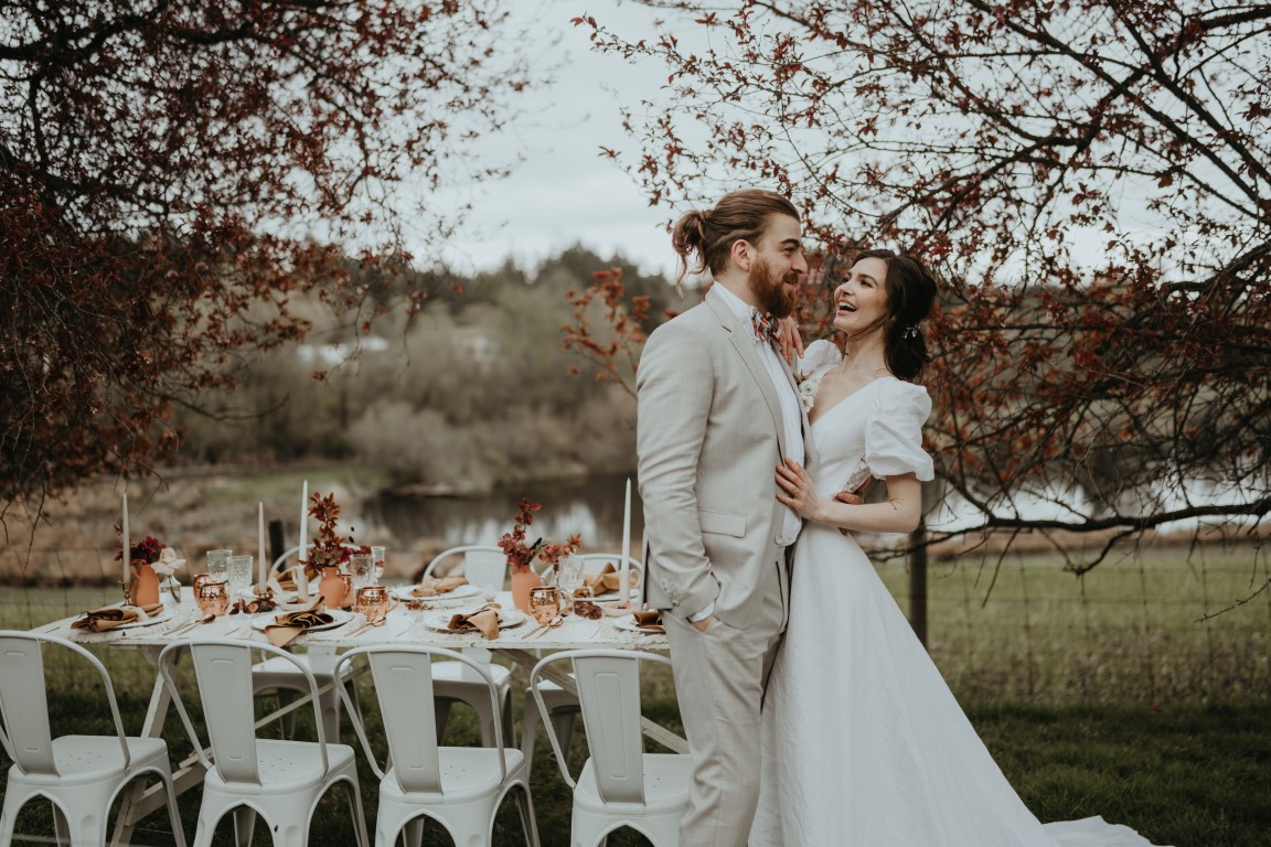 Bride and Groom at Vancouver Island ceremony in sweet embrace before sitting to dine