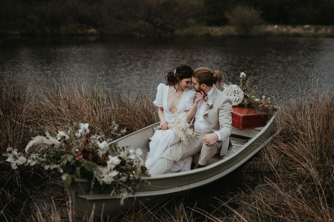 Water backdrop and bride and groom in Boat on Vancouver Island