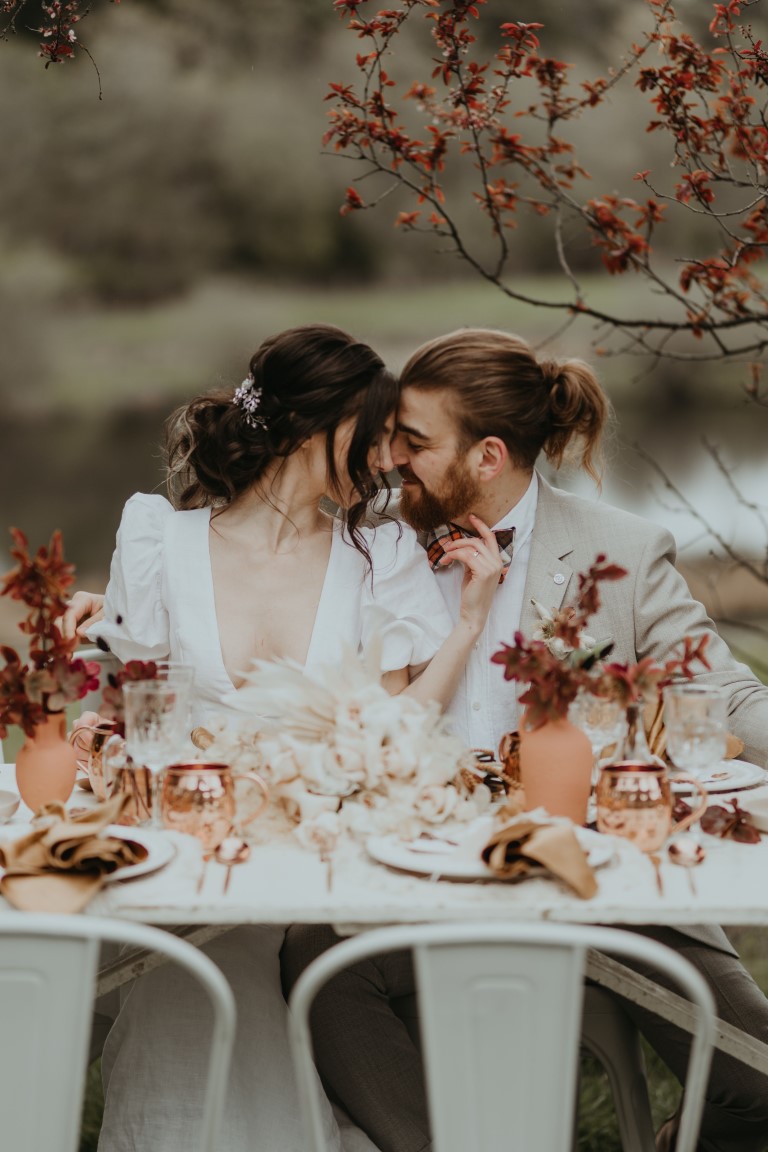 Us + Ewe outdoor farm table setting with bridal couple 