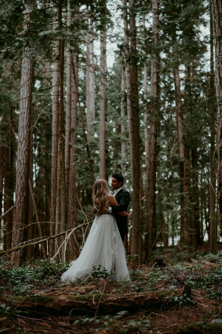Bride and groom among cedars on Vancouver Island