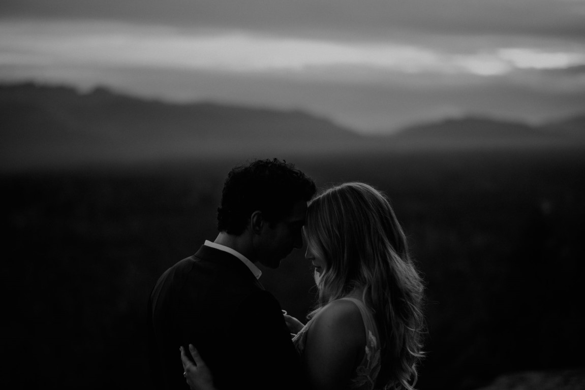 Black and white shot of newlyweds looking over BC Mountains by Dallas and Sabrina