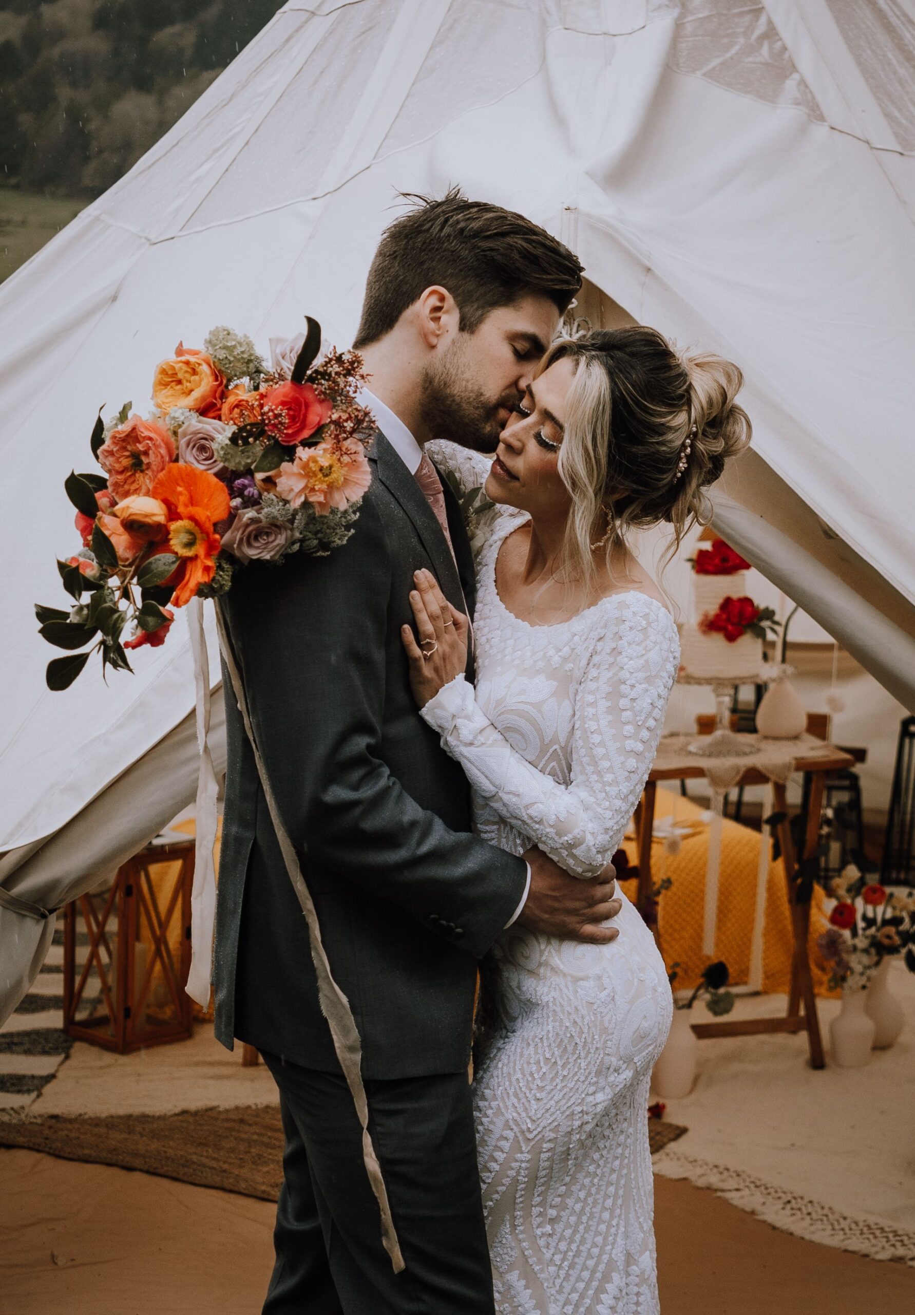 Couple embrace with bridal bouquet