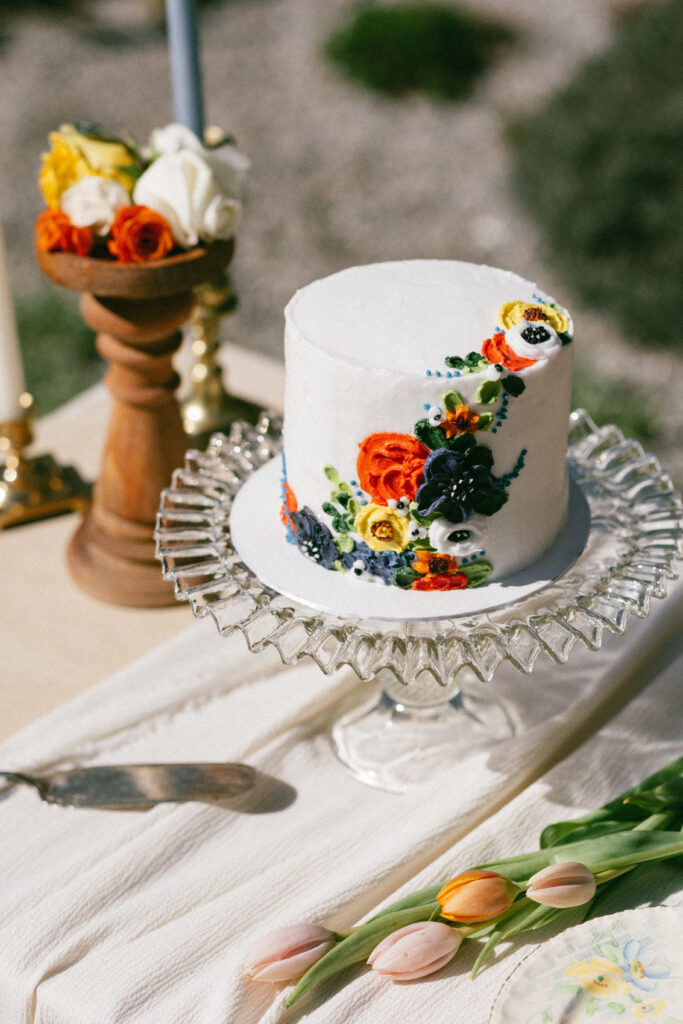 small wedding cake with floral icing details