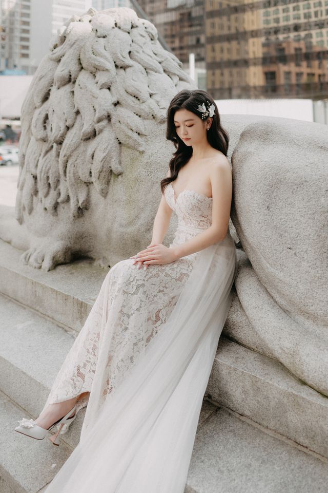 bride wearing strapless lace dress with overskirt from lace & tulips and tulle floral hair piece