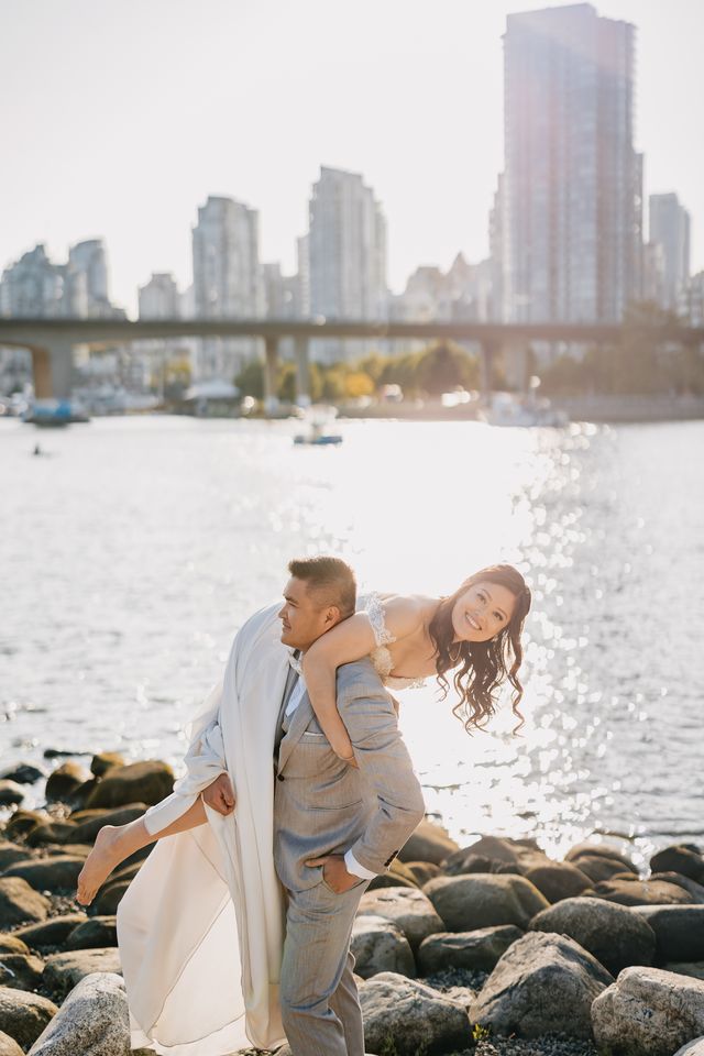 groom hold bride playfully over his shoulder