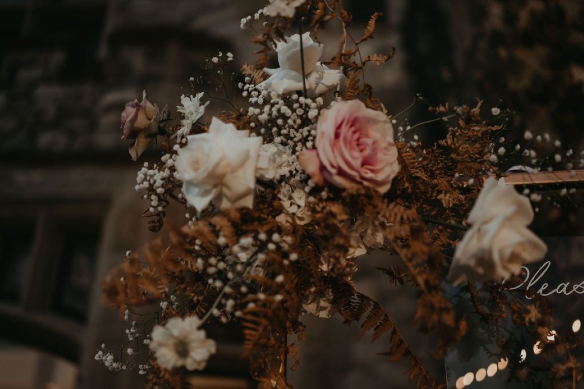 closeup shot of wedding florals on seating chart