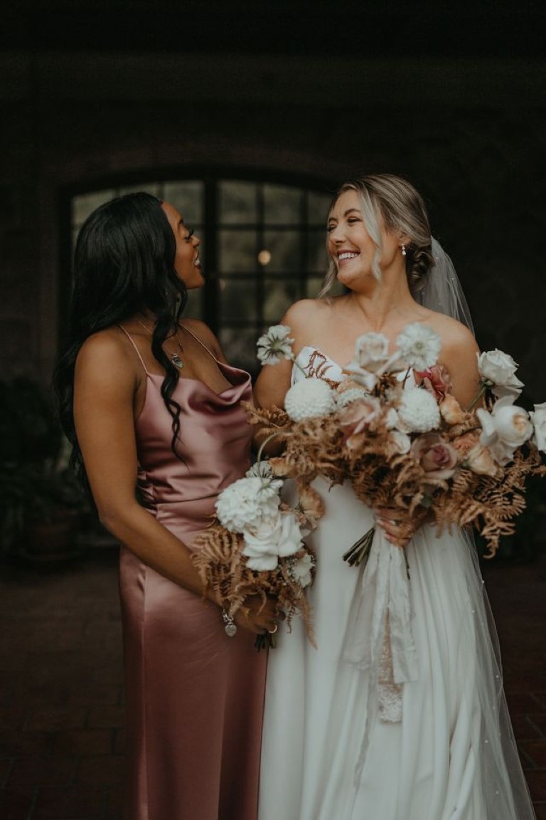 bride and bridesmaid share a laugh