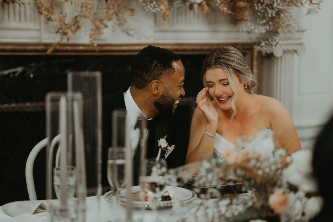 couple talks quietly at sweetheart table