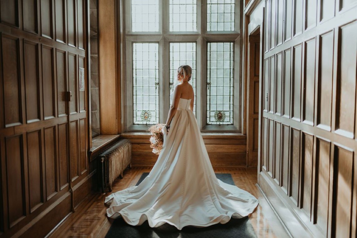 back of bridal gown in natural light hallway in Hatley Castle