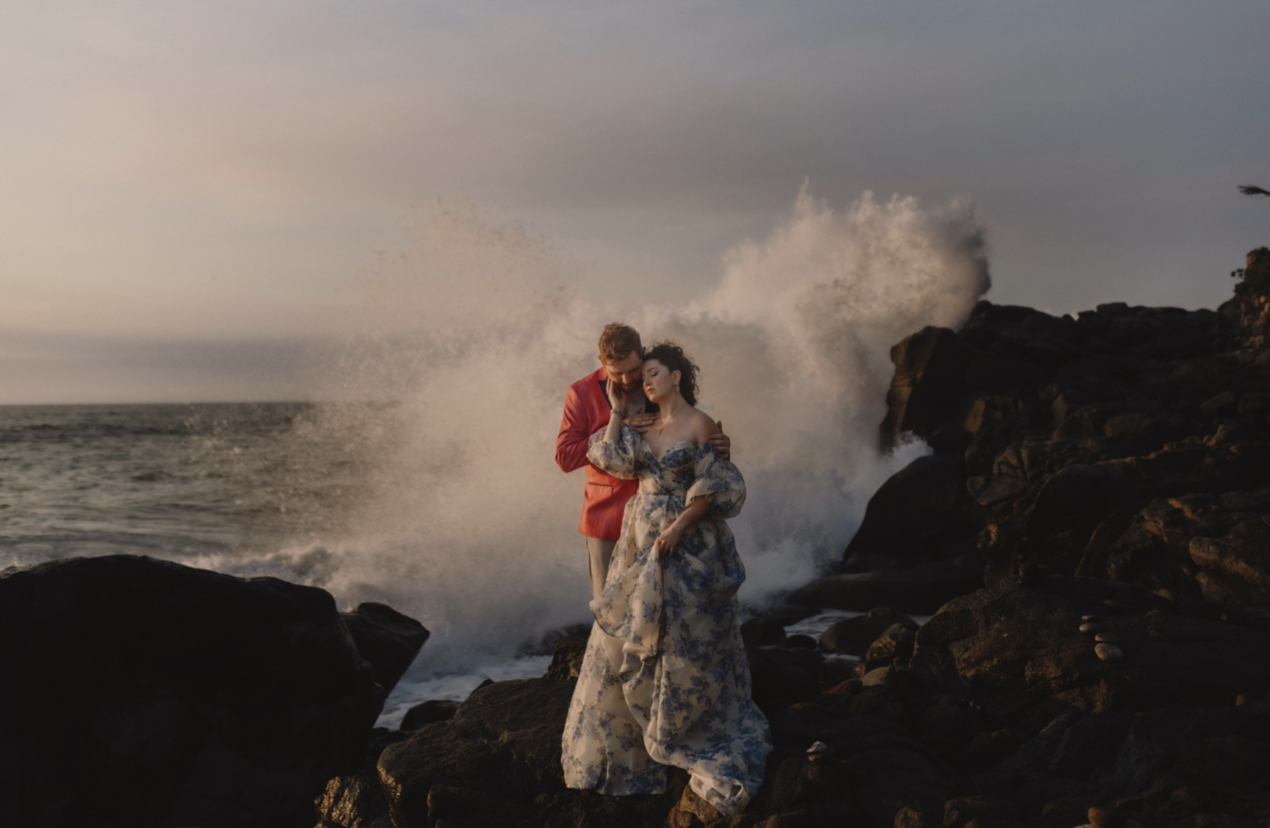 Newlyweds have rogue wave spash over them by Gabe McClintock Photography