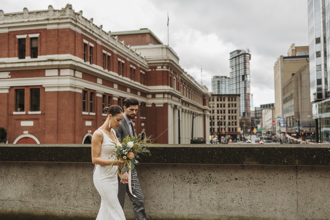 Bridal couple walk along Vancouver streets by Halle Adrian
