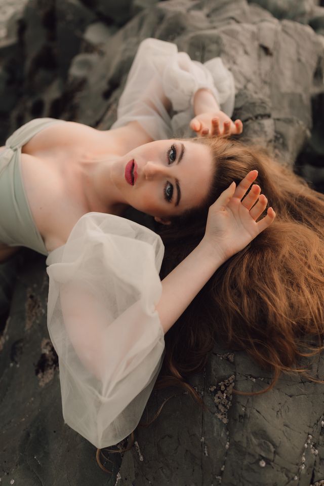 bride lays with arms on hair