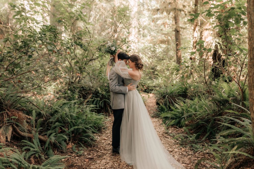 bride hugs groom around neck